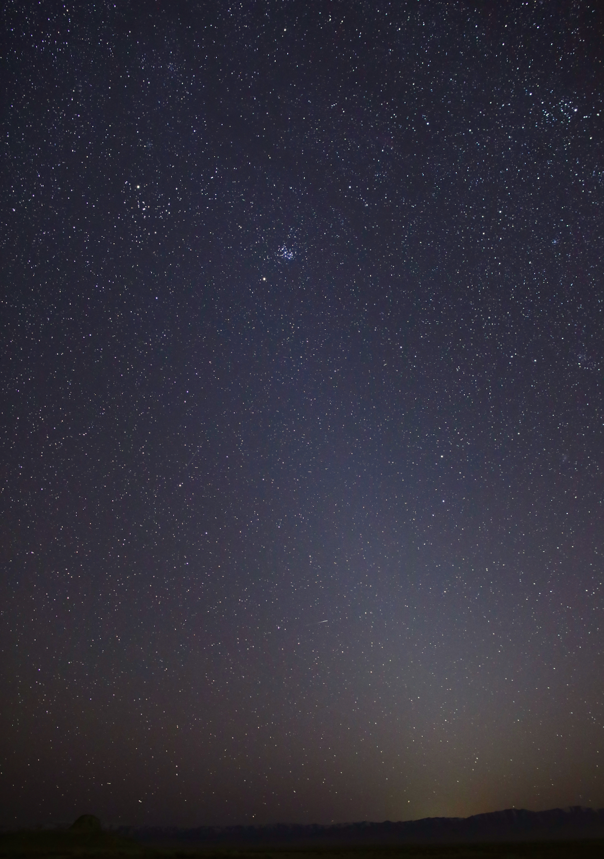 Photo of zodiacal light extending above the horizon