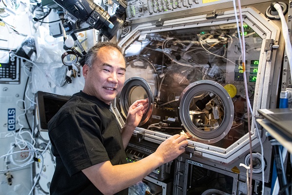 image of astronaut working on experiment