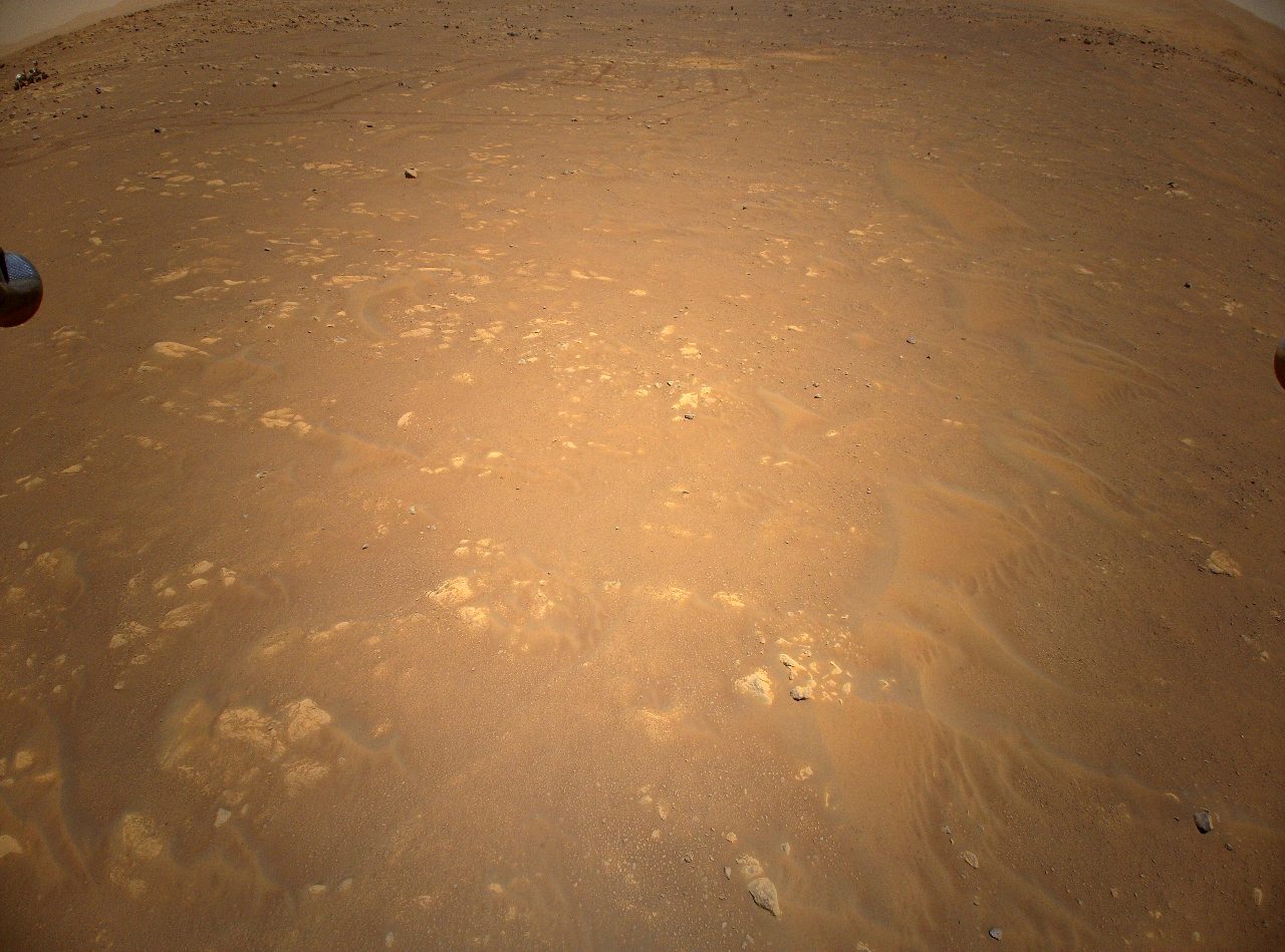 In this illustration, NASA’s Ingenuity Mars Helicopter flies above the surface of the Red Planet with the agency's Perseverance rover close by.