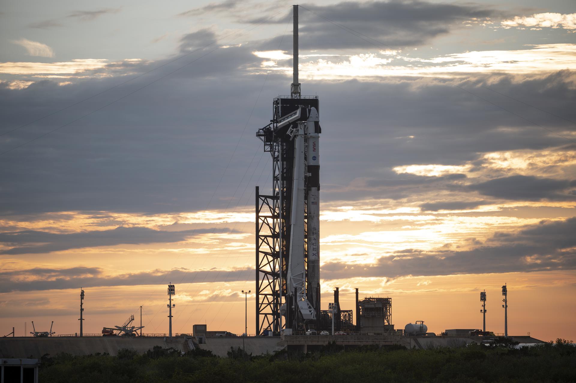 A SpaceX Falcon 9 rocket with the company's Crew Dragon spacecraft onboard is seen at sunset on the launch pad at Launch Complex 39A as preparations continue for the Crew-2 mission, Monday, April 19, 2021, at NASA’s Kennedy Space Center in Florida. NASA’s SpaceX Crew-2 mission is the second crew rotation mission of the SpaceX Crew Dragon spacecraft and Falcon 9 rocket to the International Space Station as part of the agency’s Commercial Crew Program.