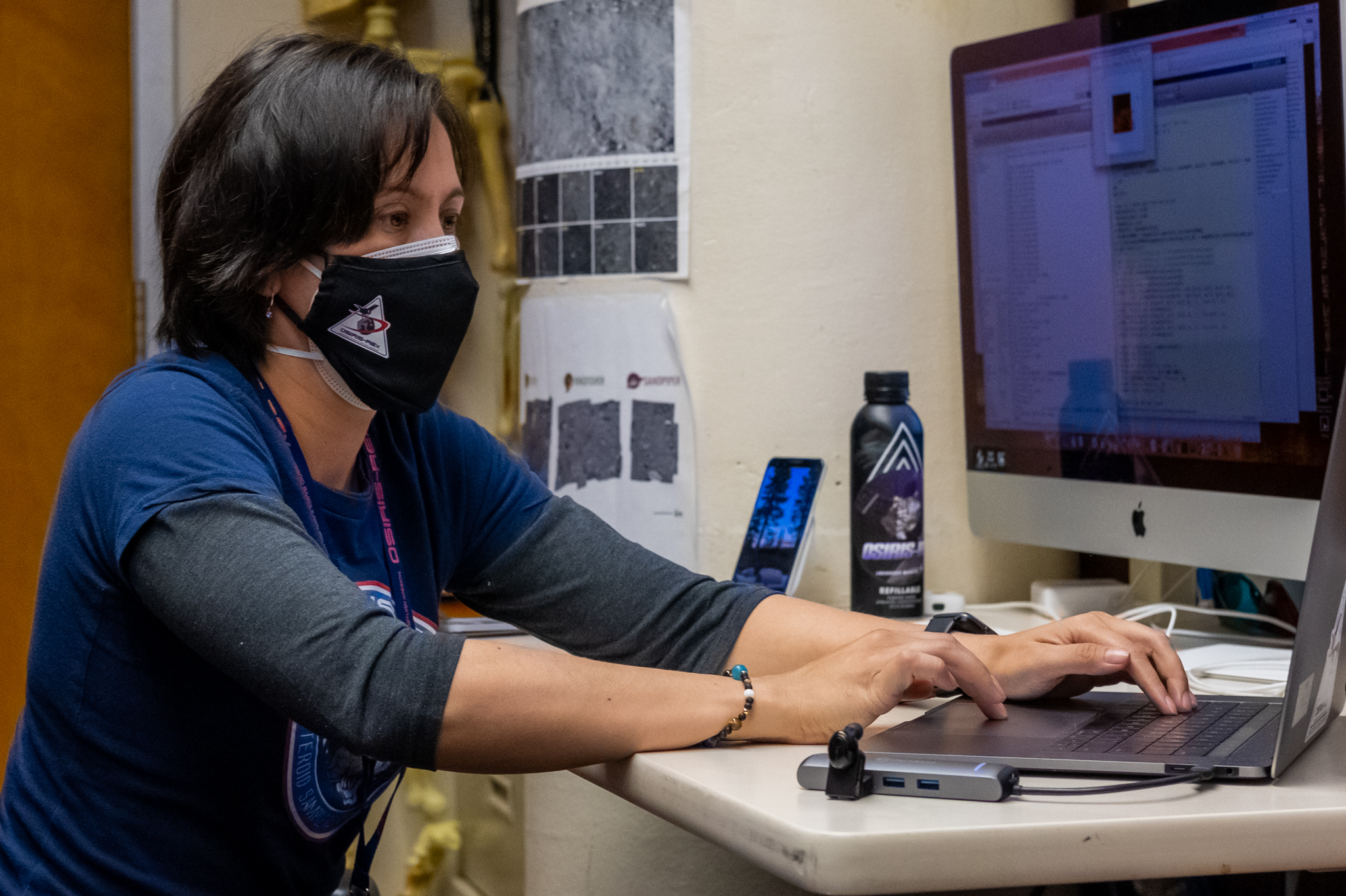 masked woman at computer