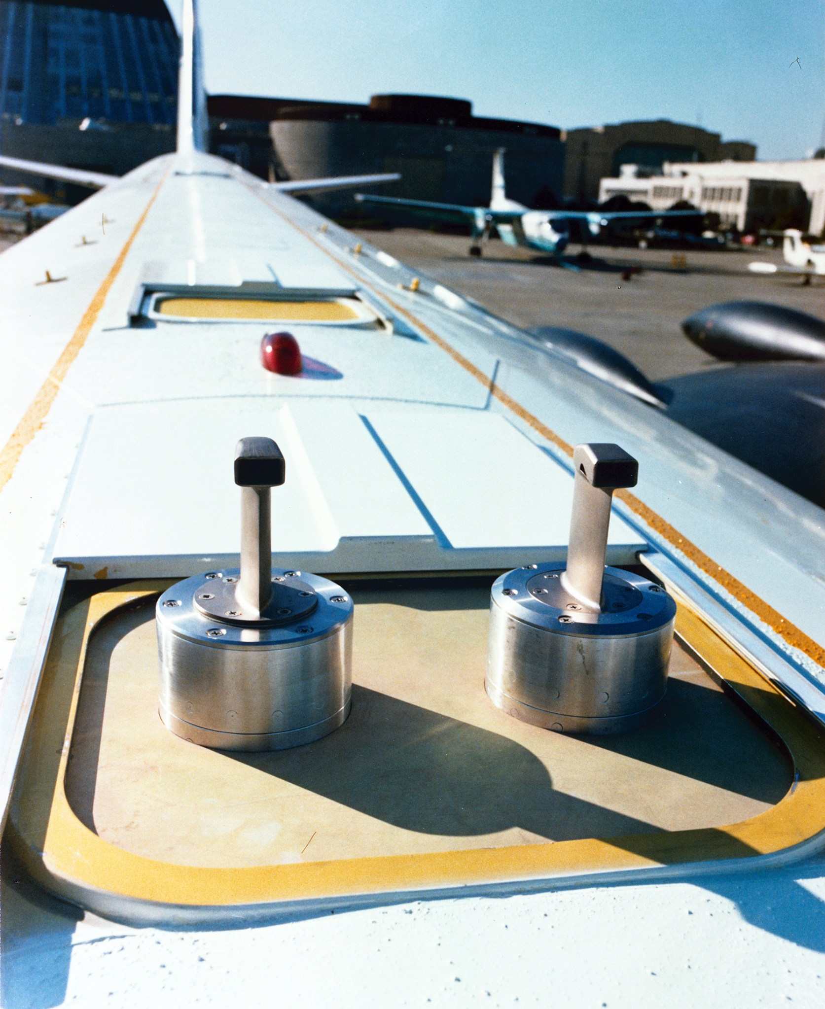 Metal probes are mounted on top of an airliner.