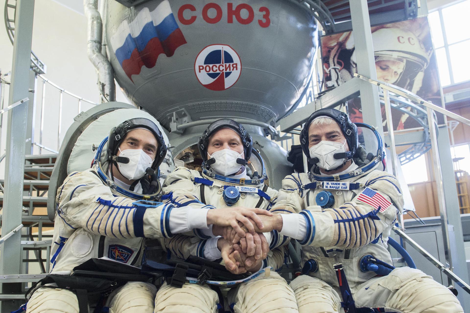 Cosmonauts Pyotr Dubrov of Roscosmos, left, and Oleg Novitskiy, center, of Roscosmos, and NASA astronaut Mark Vande Hei 