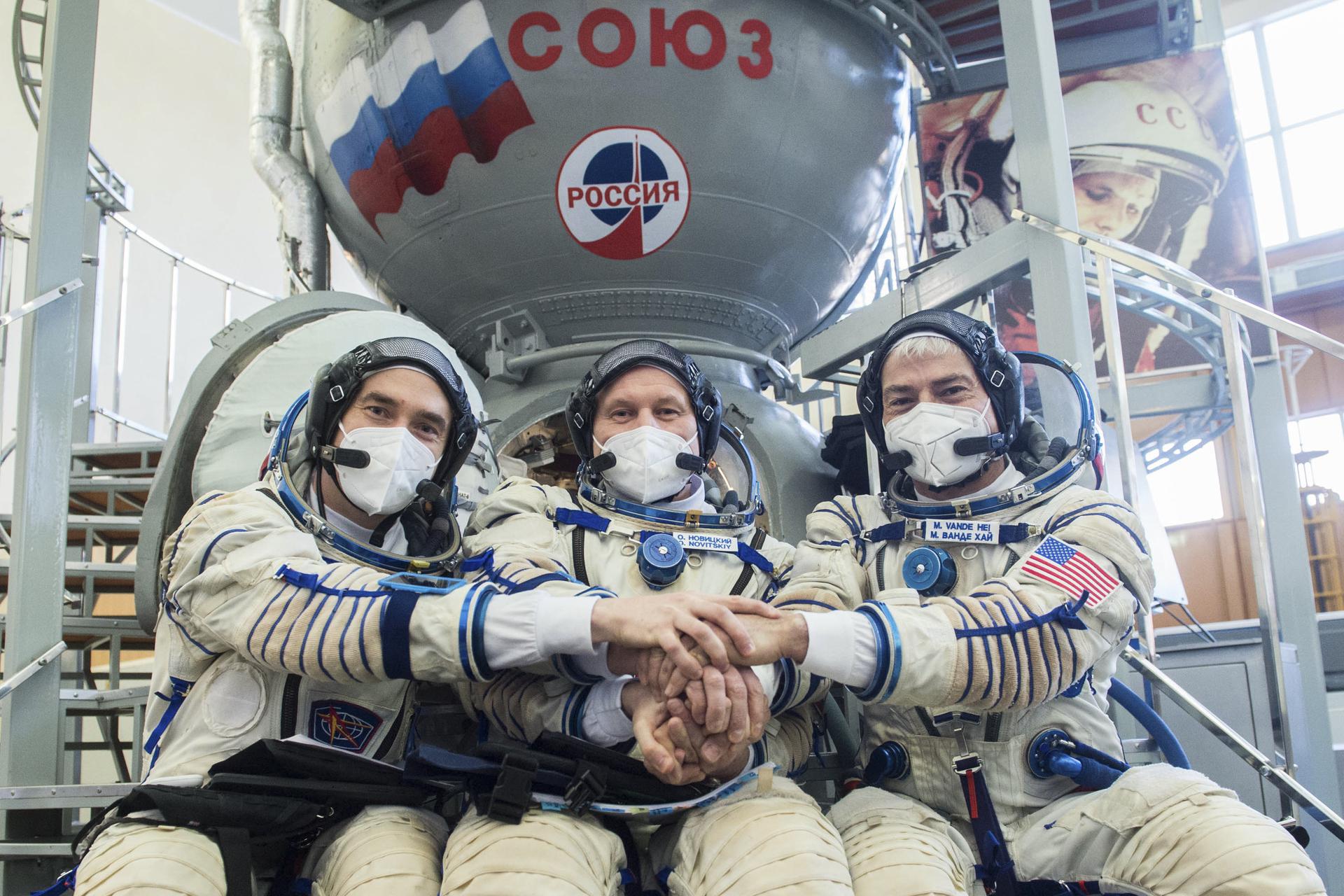 Cosmonauts Pyotr Dubrov of Roscosmos, left, and Oleg Novitskiy, center, of Roscosmos, and NASA astronaut Mark Vande Hei