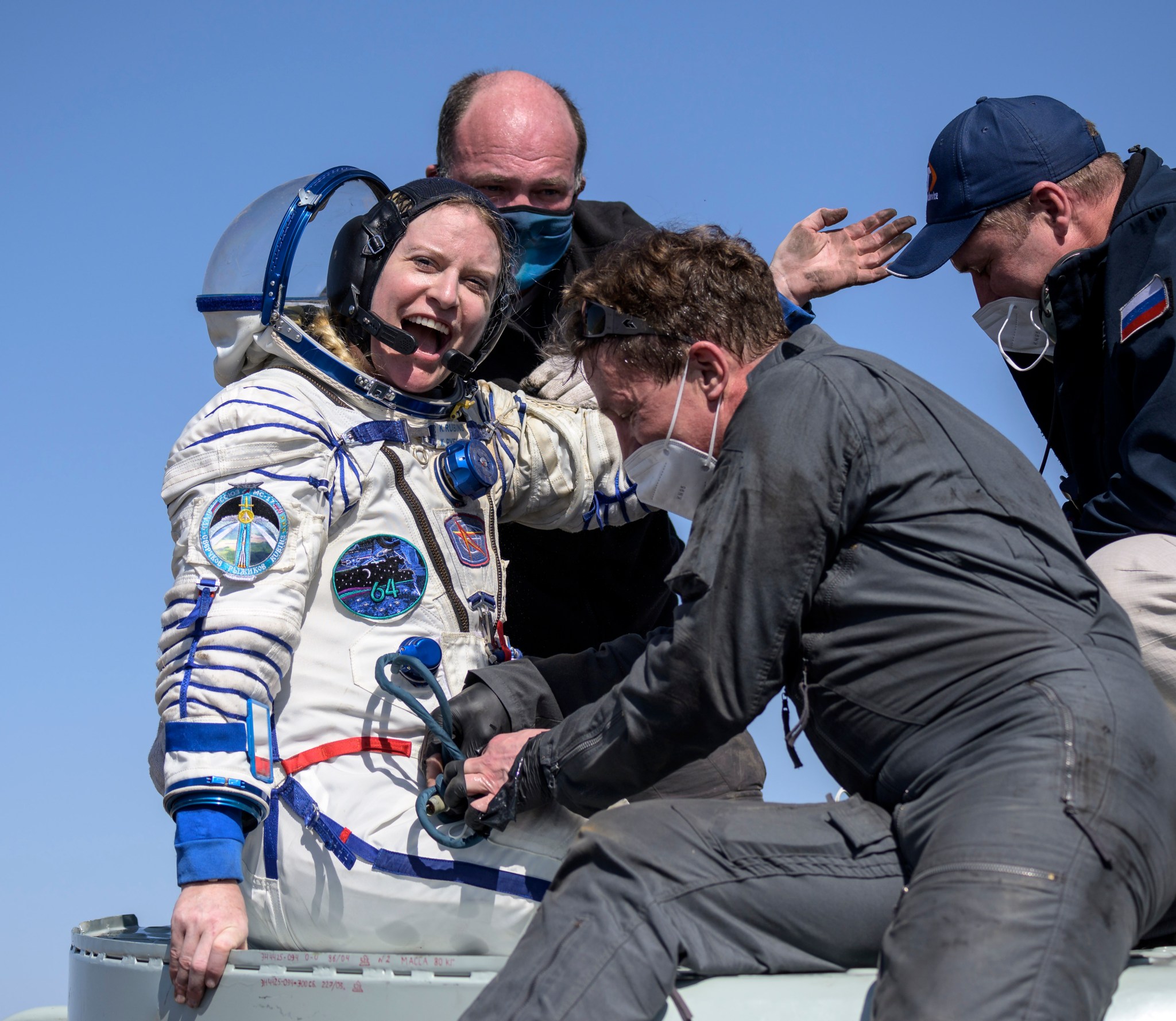 NASA astronaut Kate Rubins is helped out of the Soyuz MS-17 spacecraft