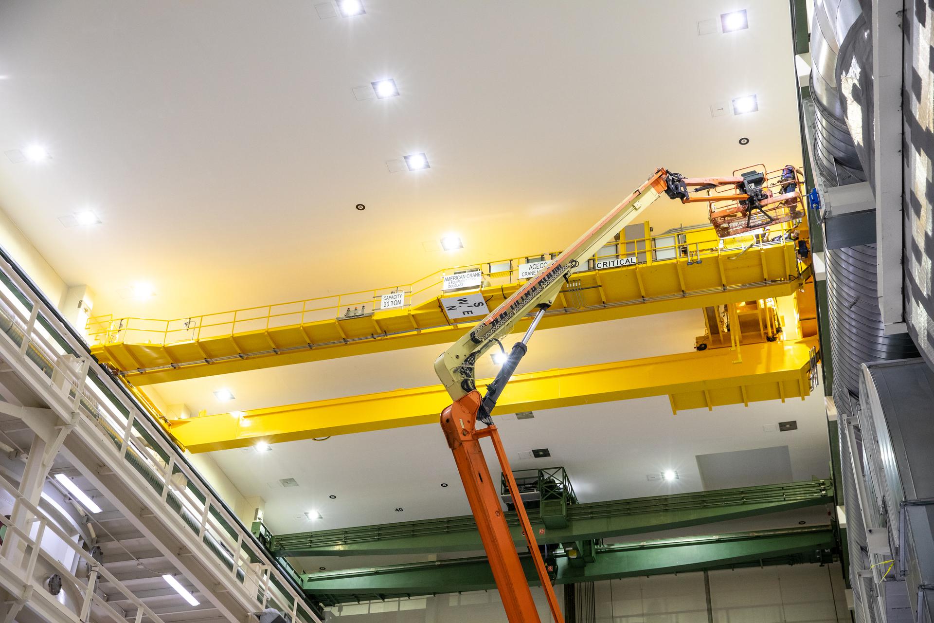 A new overhead crane is installed in the Operations and Checkout Building high bay at Kennedy Space Center.