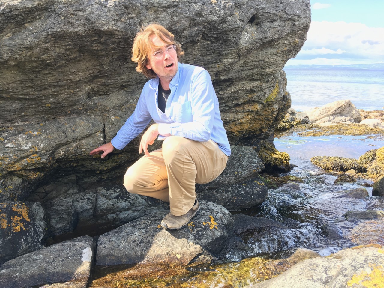 Tom in front of a rock