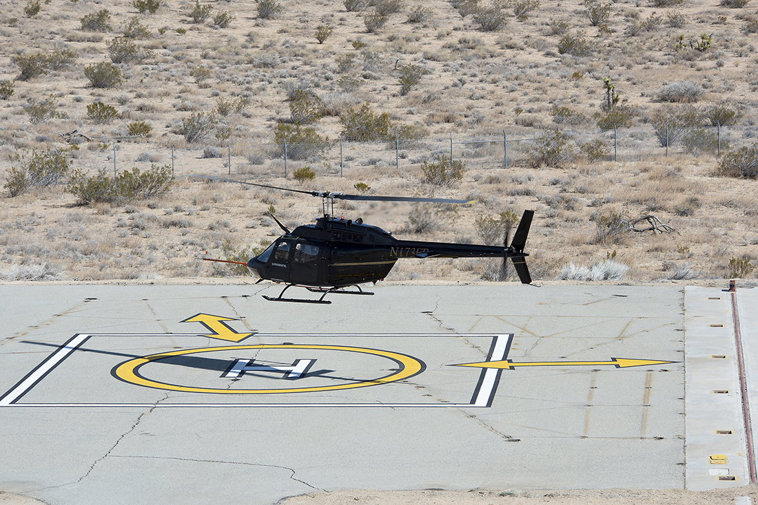 Flight Research Inc.’s Bell OH-58C Kiowa helicopter takes off from a research helipad 