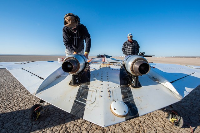 The X-56B remotely piloted aircraft ground crew prepares the aircraft to begin a new flight series