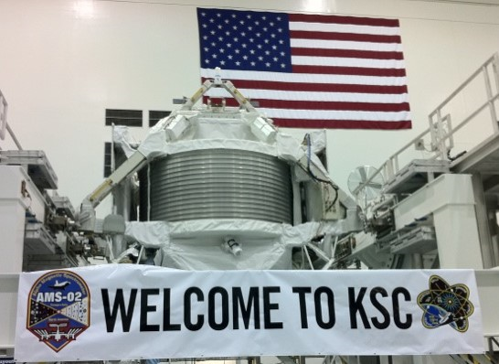 ams_2_shortly_after_arrival_at_ksc_rotated_upside_down_with_banner