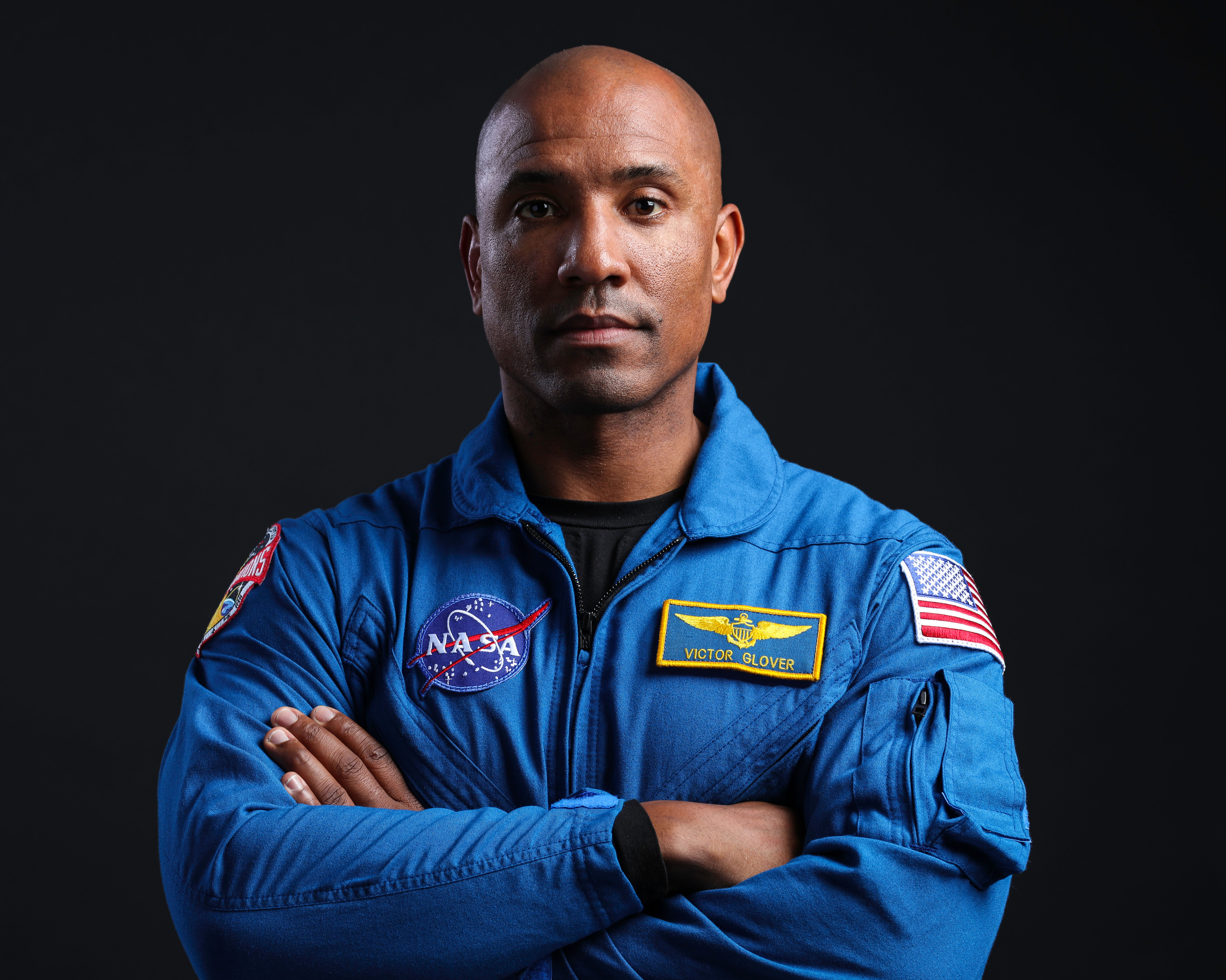 NASA's SpaceX Crew-1 Pilot Victor Glover is photographed in his blue NASA flight suit.