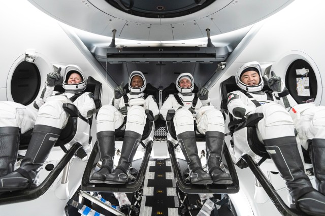 The crew members for NASA's SpaceX Crew-1 mission are photographed seated inside SpaceX's Dragon spacecraft.