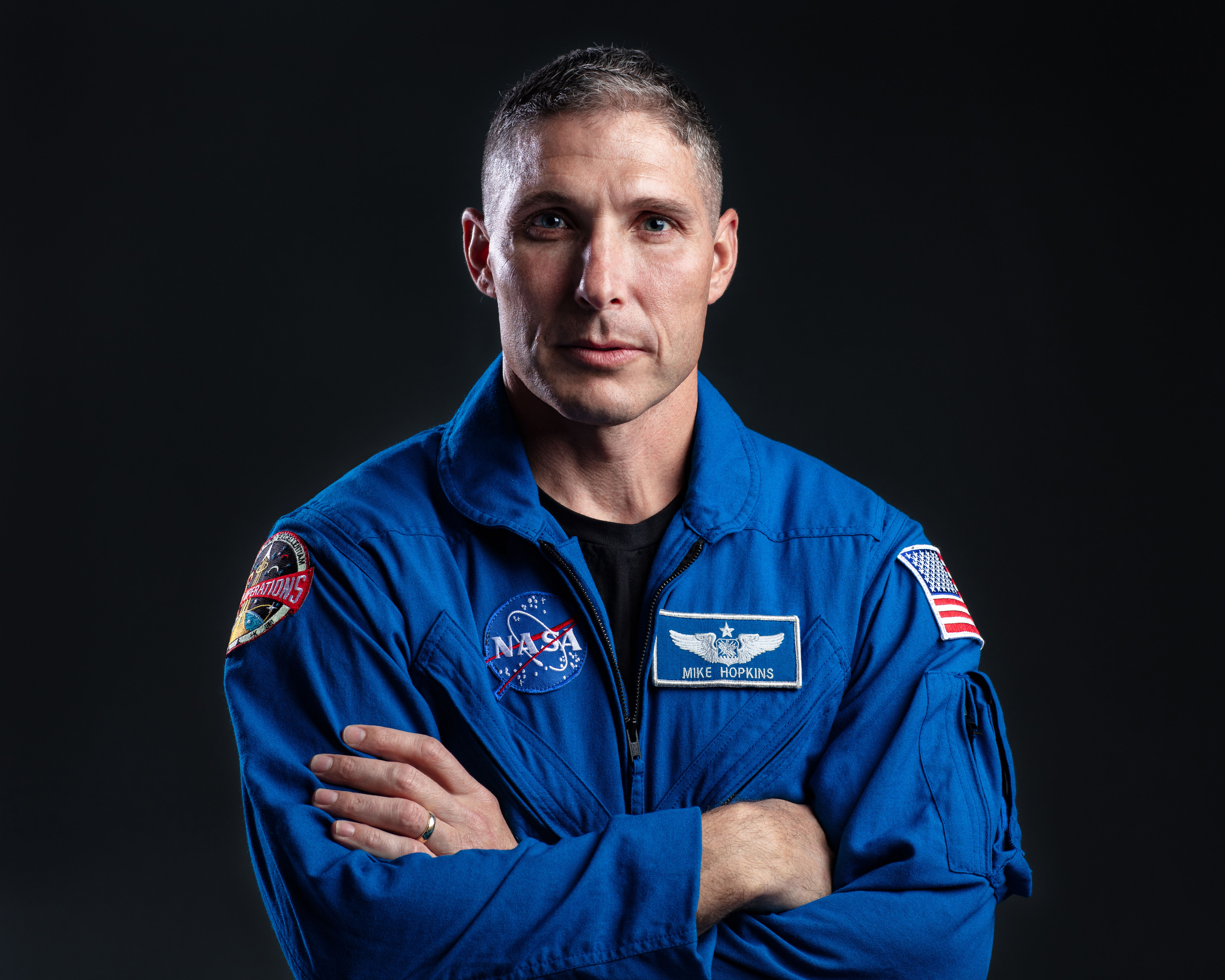 NASA's SpaceX Crew-1 Spacecraft Commander Mike Hopkins is photographed in his blue NASA flight suit.