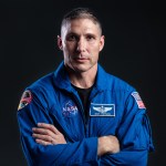 NASA's SpaceX Crew-1 Spacecraft Commander Mike Hopkins is photographed in his blue flight suit.