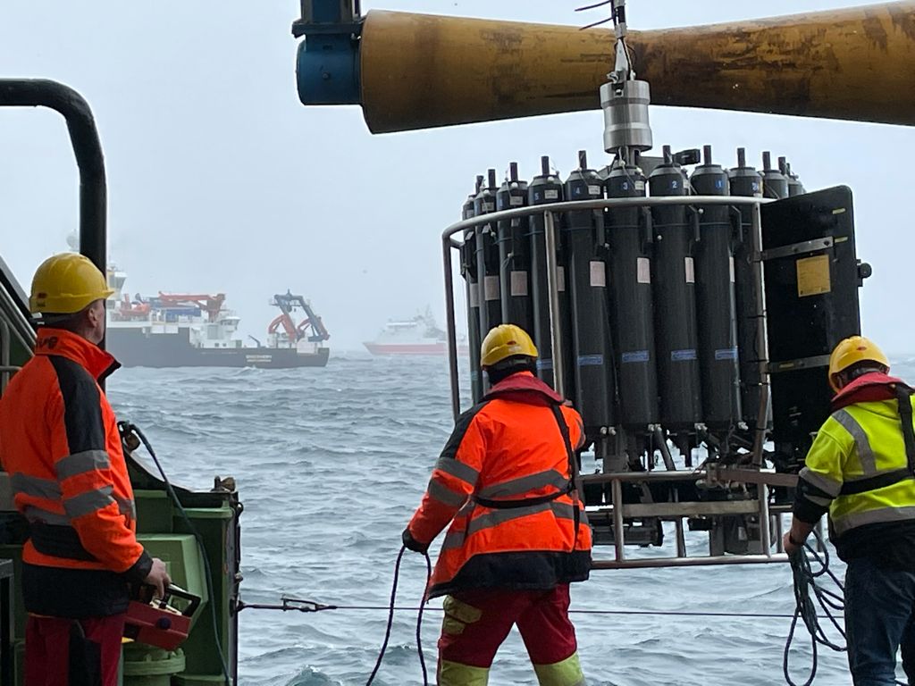 Science and crew aboard the RRS James Cook, pulling in a large testing instrument.