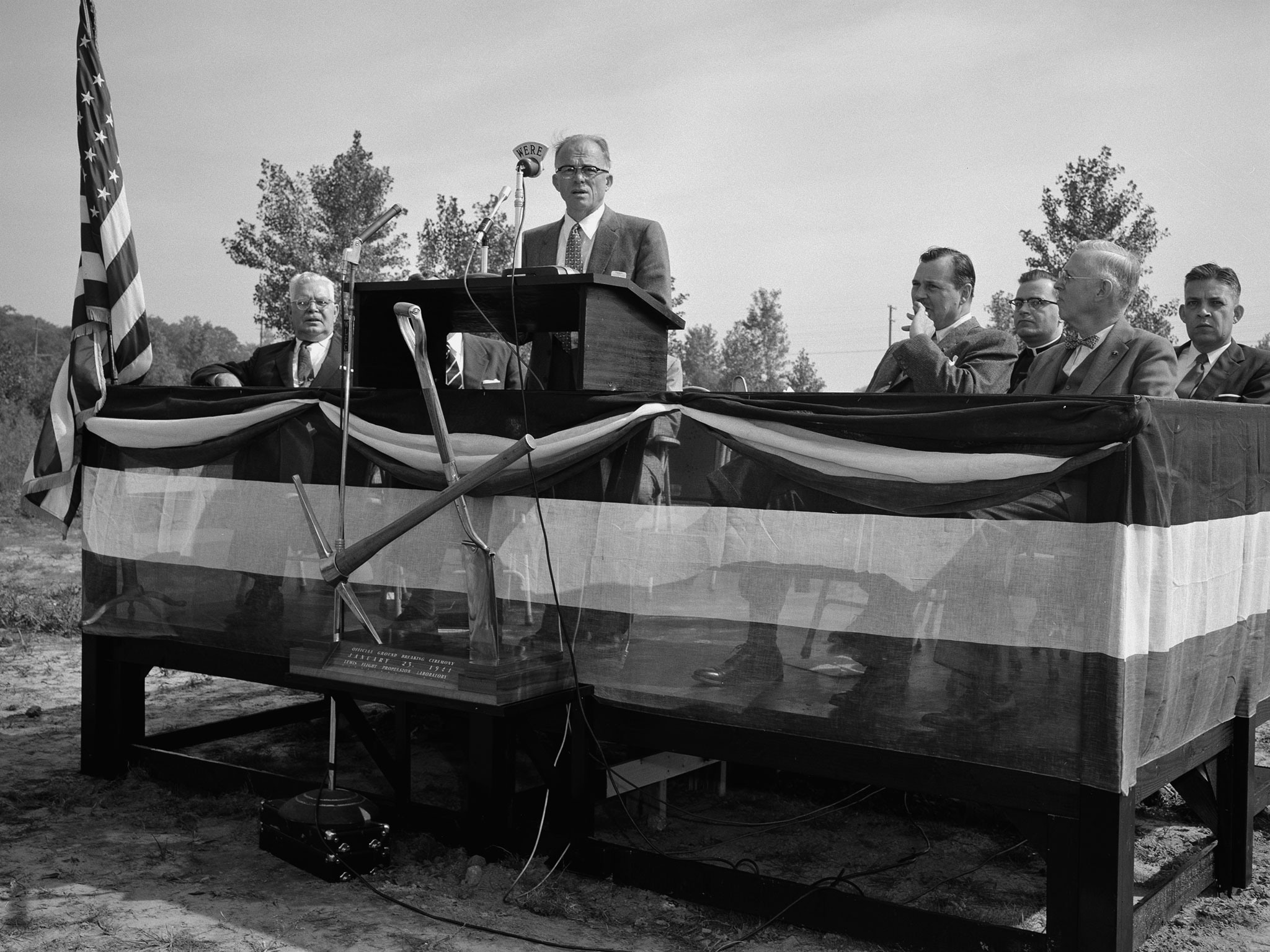 Addison Rothrock, speaking from podium on a grandstand.