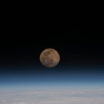 A Full Moon above the Earth's horizon