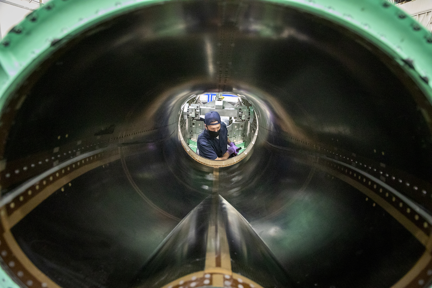 A photo of Lockheed Martin employee completing the final mating of the wing assembly of the SEG 500 Empennage, SEG 400.