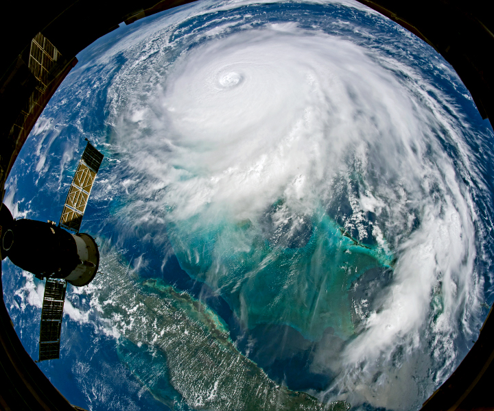 View from the International Space Station showing the white spiral clouds of Hurricane Dorian dominating the ocean.