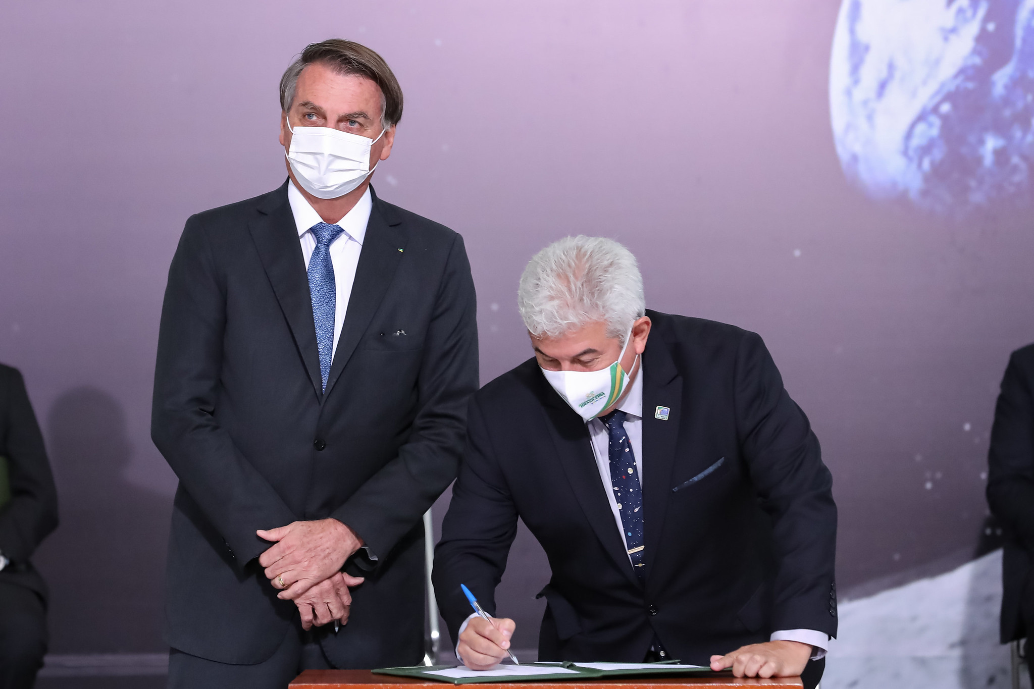 Brazil Minister of Science, Technology, and Innovation Marcos Pontes signs the Artemis Accords as President Jair Bolsonaro looks on during a ceremony at the Palácio do Planalto in Brasilia Tuesday, June 15, 2021.