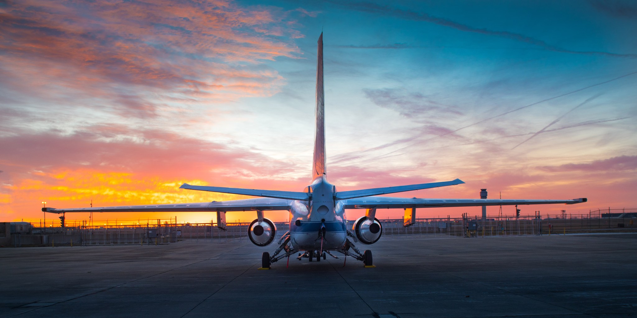 A research aircraft is seen from behind facing a beautiful sunset at Cleveland Hopkins Airport.