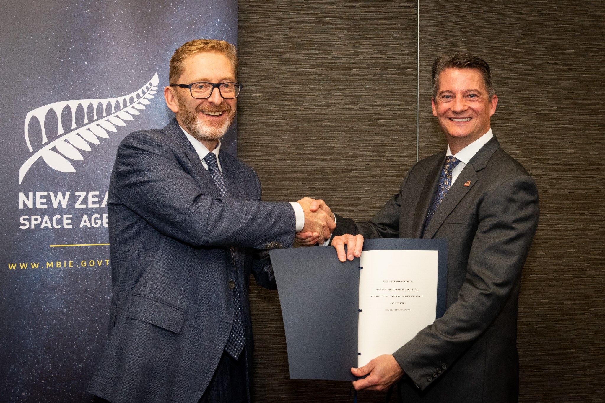 Dr. Peter Crabtree, head of the New Zealand Space Agency, left, and Charge d'Affaires Kevin Cover of the U.S. Embassy in New Zealand pose following an Artemis Accords signing ceremony in Wellington, New Zealand, May 31, 2021.