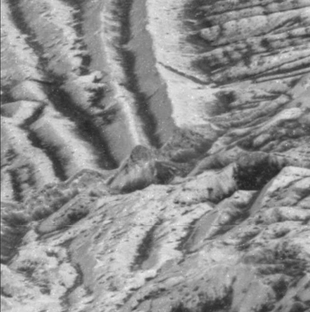 In this zoomed-in image of Europa’s surface, captured by NASA’s Galileo mission, the thin, bright layer, visible atop a cliff in the center shows the kind of areas churned by impact gardening.