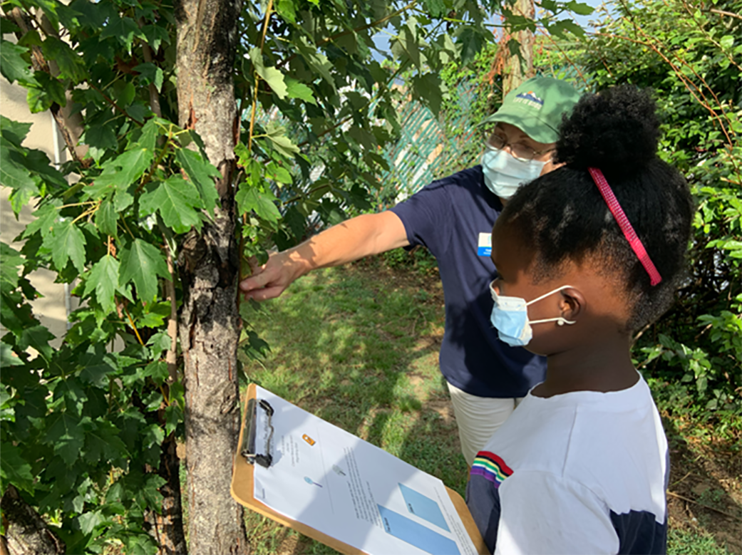 2 women looking at a tree for the GLOBE program