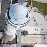 Aerial view of Boeing's Starliner spacecraft on top of a rocket.