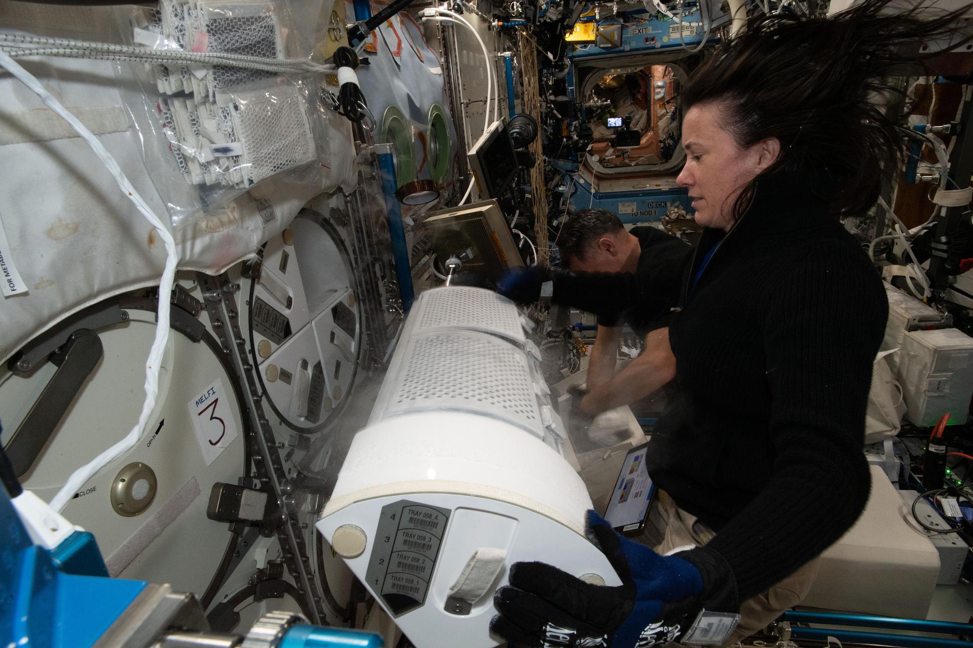 NASA astronaut and Expedition 65 Flight Engineer Megan McArthur prepares frozen research samples July 8.
