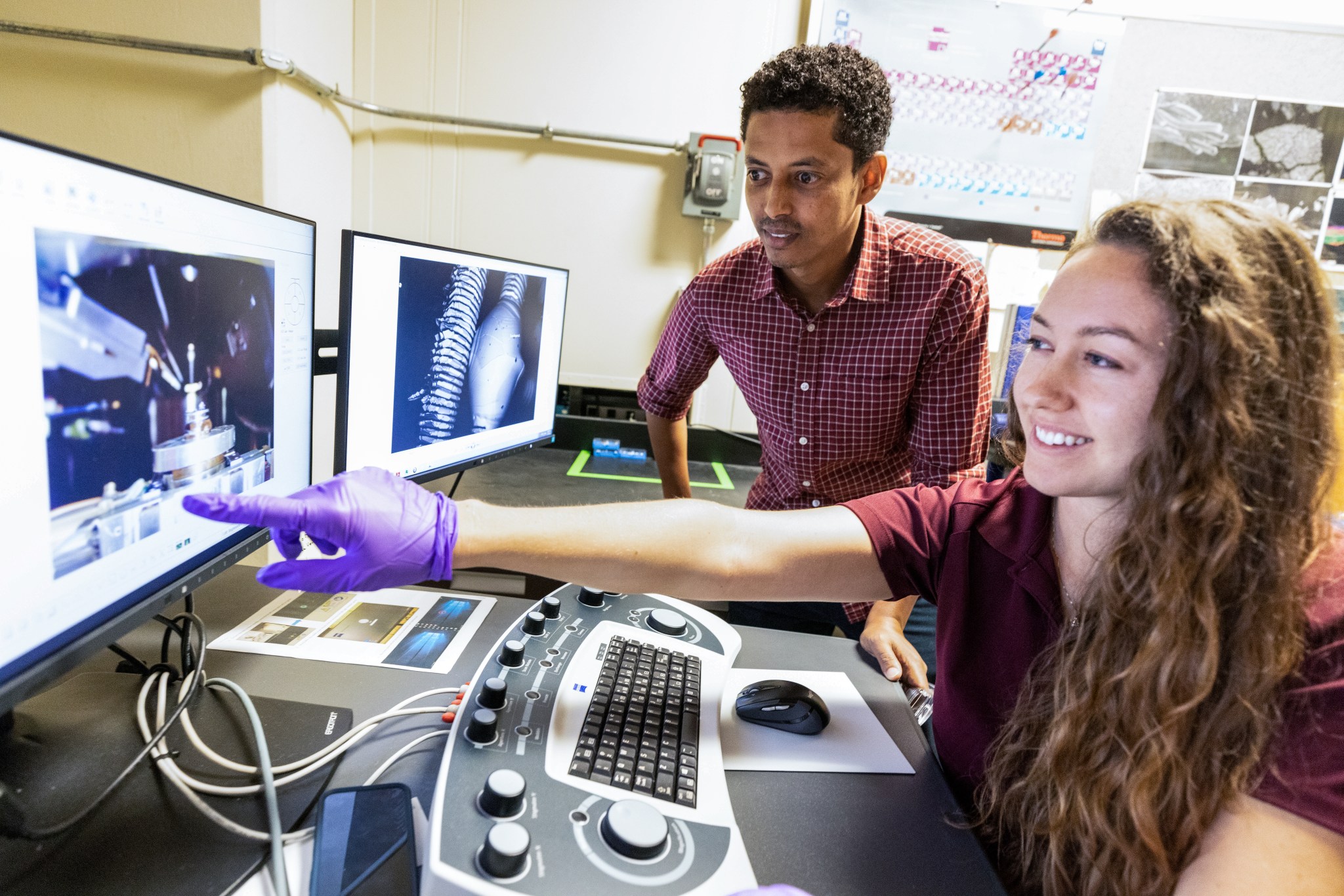Chemists Misle Tessema (left) and Macy Mullen (right) discuss scanning electron microscope operations inside NASA Engineering’s Analytical Laboratories at Kennedy Space Center in Florida on July 7, 2021.