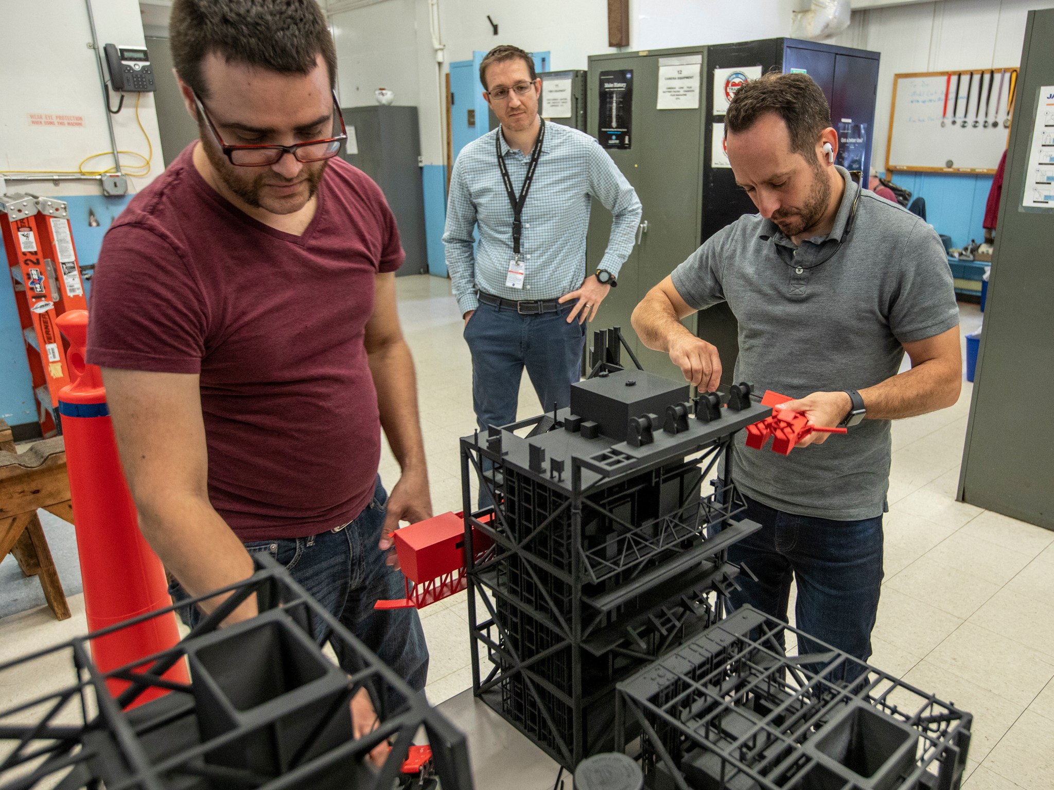 engineers prep the mobile launcher structure model for wind tunnel testing