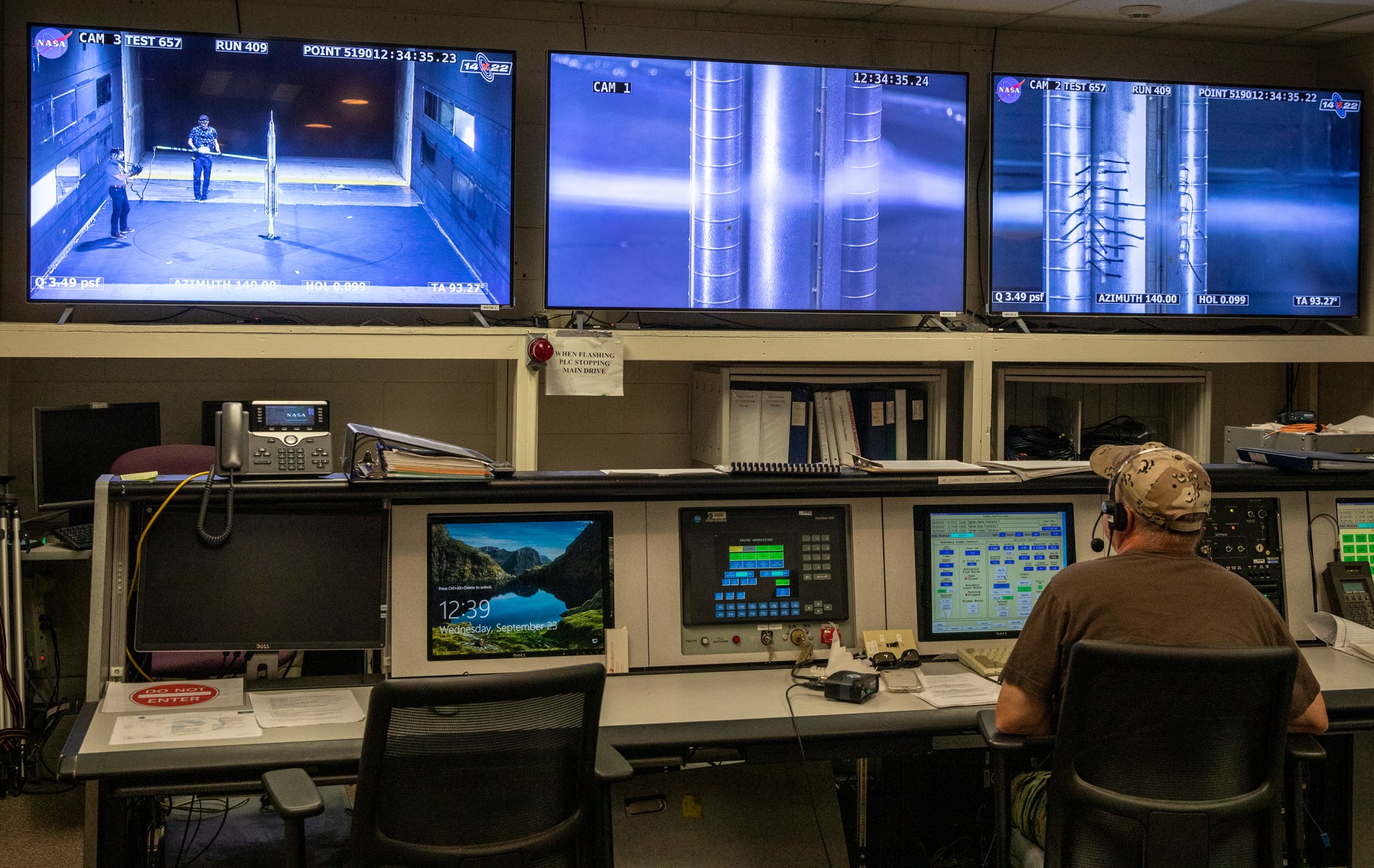 Engineer watches monitors during smoke flow test in 14x22 wind tunnel