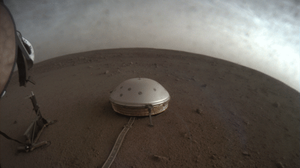Clouds drift over the dome-covered seismometer, known as SEIS, belonging to NASA's InSight lander, on Mars.
