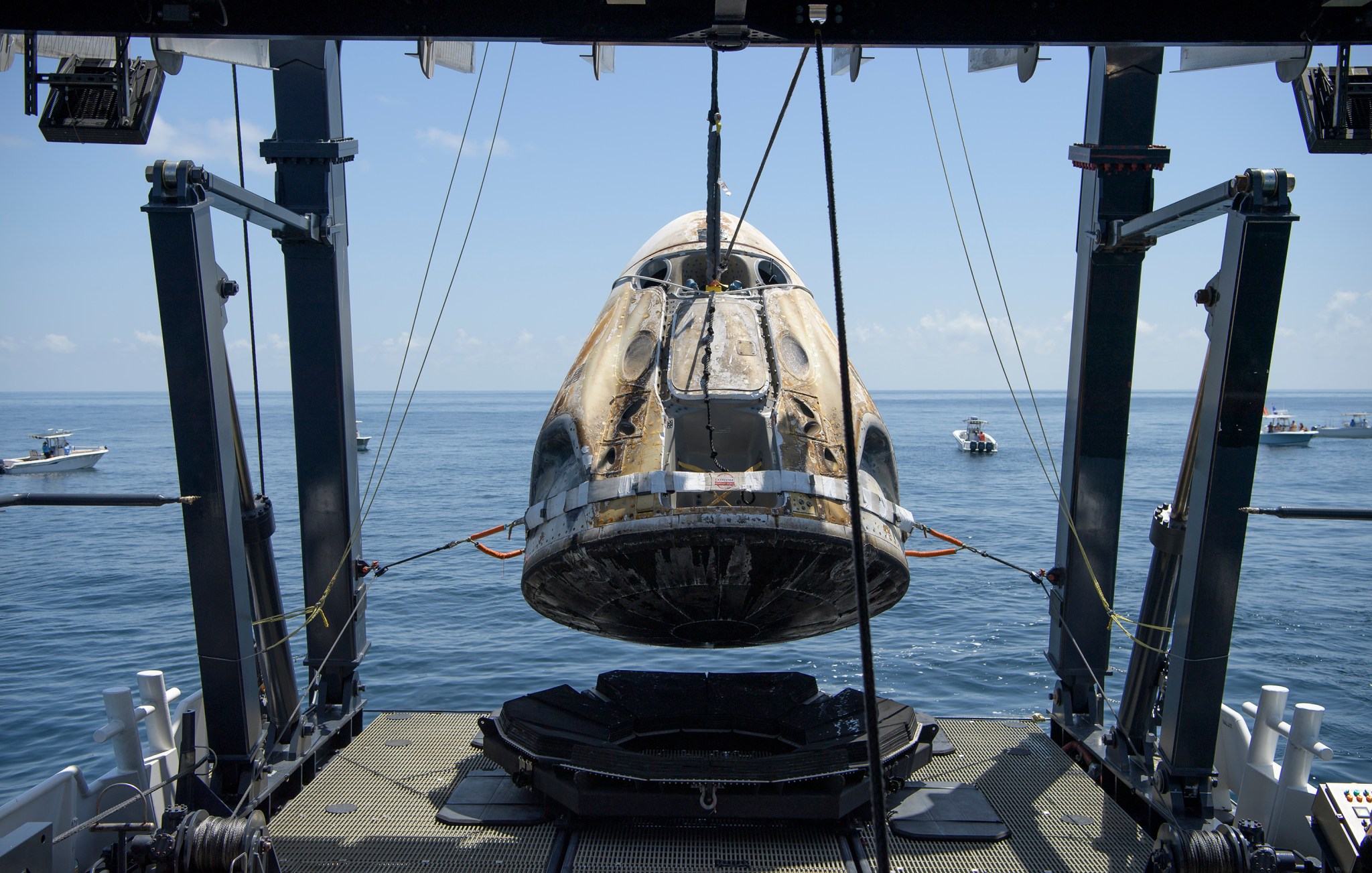 Teams recover the Crew Dragon spacecraft after it splashes down in the Gulf of Mexico, marking the completion of SpaceX's Demo-2 mission.