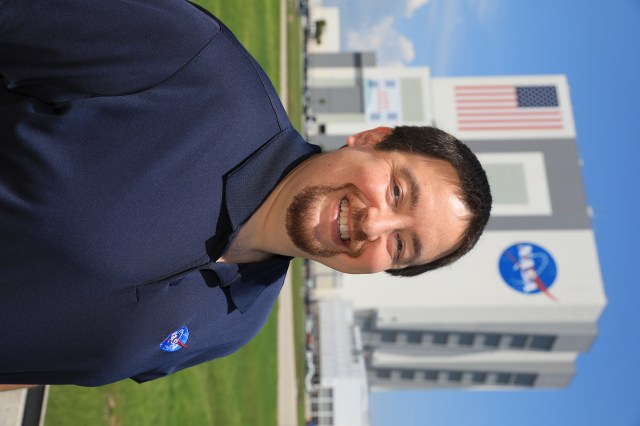 A photo of Kennedy Space Center's Slade Peters with the Vehicle Assembly Building in the background.