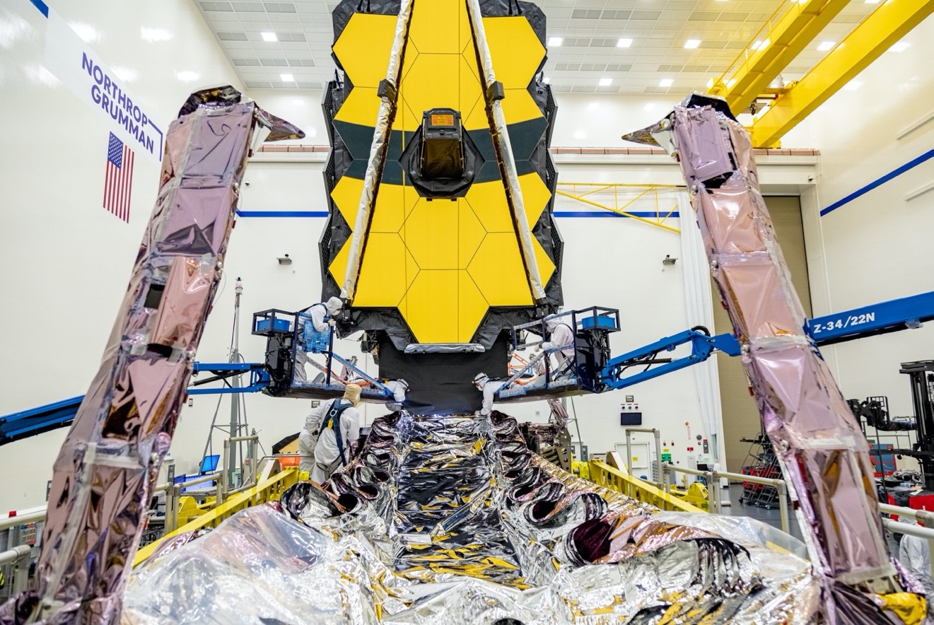 Testing teams can be seen carefully working a critical part of the observatory known as the deployable tower assembly that helps Webb maintain its sub-zero operating temperature.