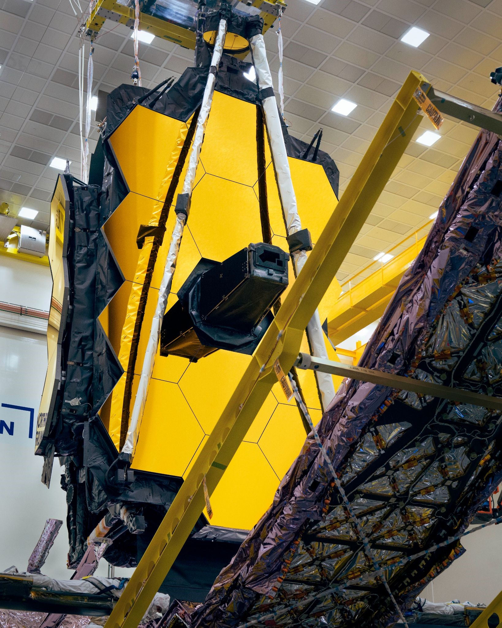 After the removal of the James Webb Space Telescope’s “lens cap” engineers were freed to fold up the long support structures that keep the observatory’s sunshield safe.