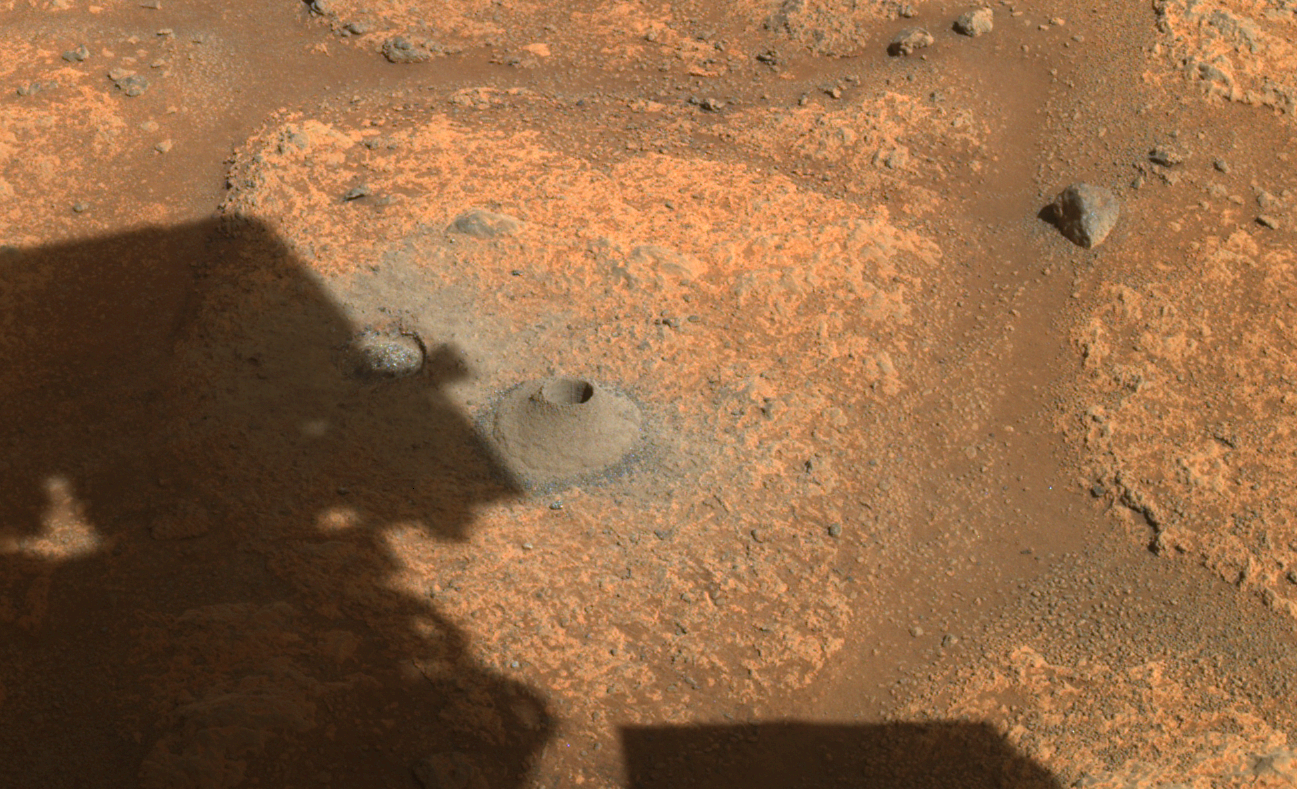 This image taken by one the hazard cameras aboard NASA’s Perseverance rover on Aug. 6, 2021, shows the hole drilled in what the rover’s science team calls a “paver rock” in preparation for the mission’s first attempt to collect a sample from Mars.