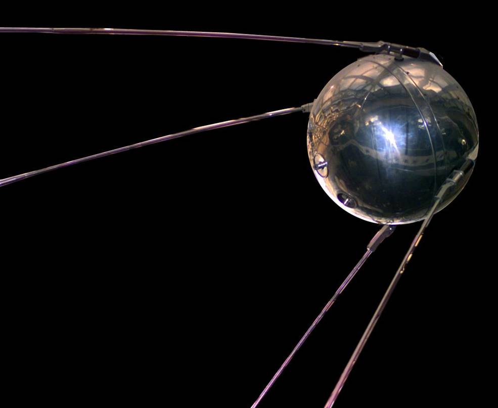 Replica of the Sputnik satellite which appears as a silver ball with four rods trailing from it.