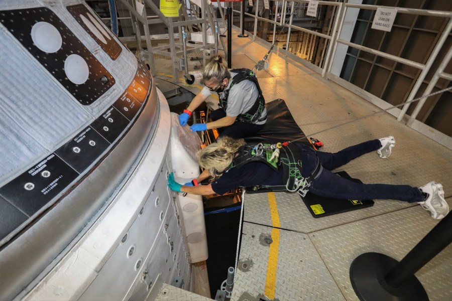 Boeing engineers continue work at the United Launch Alliance Vertical Integration Facility on the Starliner propulsion system valves.