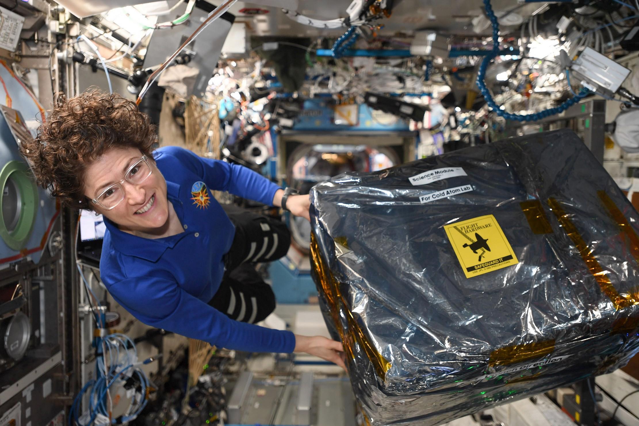 Astronaut Christina Koch unloads new hardware for the Cold Atom Lab aboard the International Space Station the week of Dec. 9, 2019.