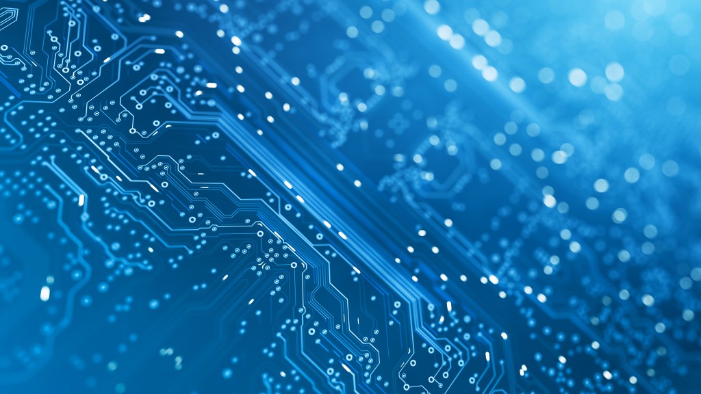 Close-up photo of a computer chip tinted blue showing lines and dots that provide power.
