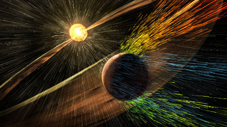 This artist’s rendering shows a solar storm hitting Mars and stripping ions from the planet's upper atmosphere.