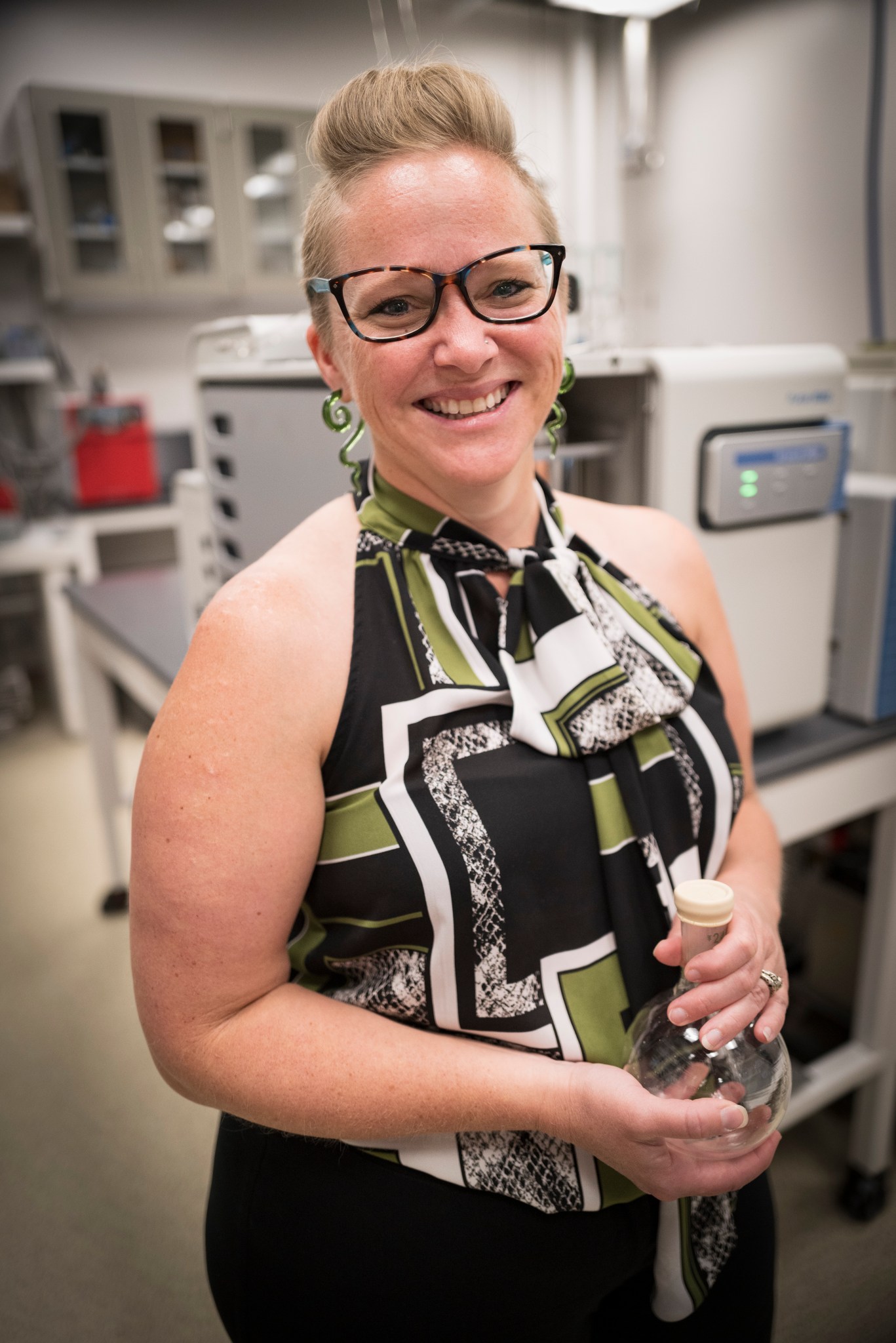 Bethany poses with a Florence flask in her lab