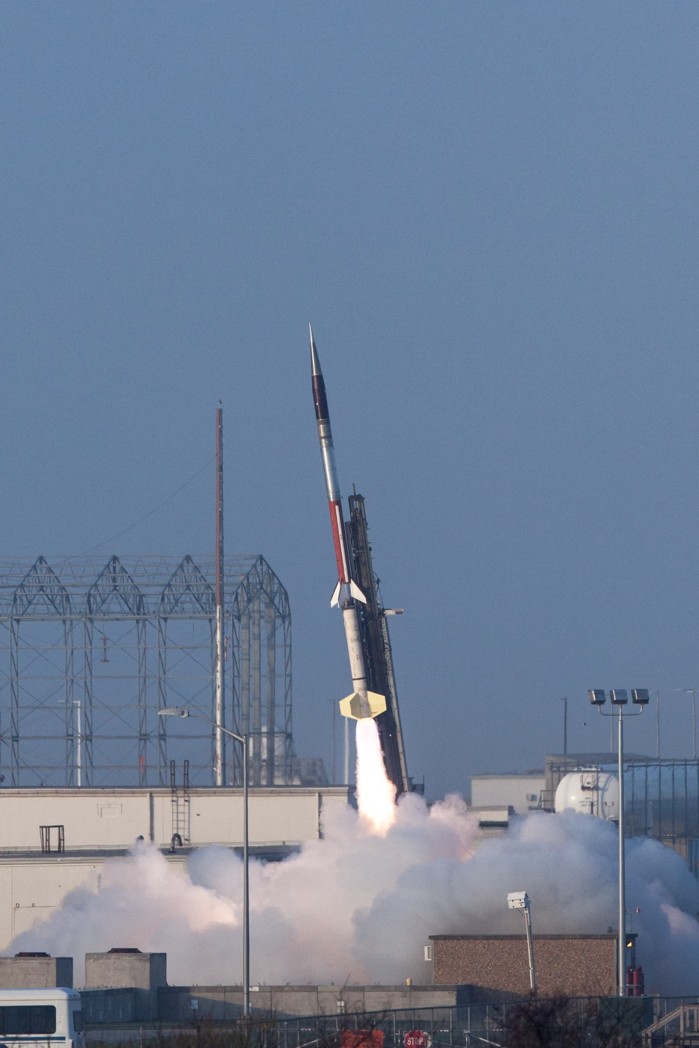 sounding launch launching from launcher against pale blue sky.