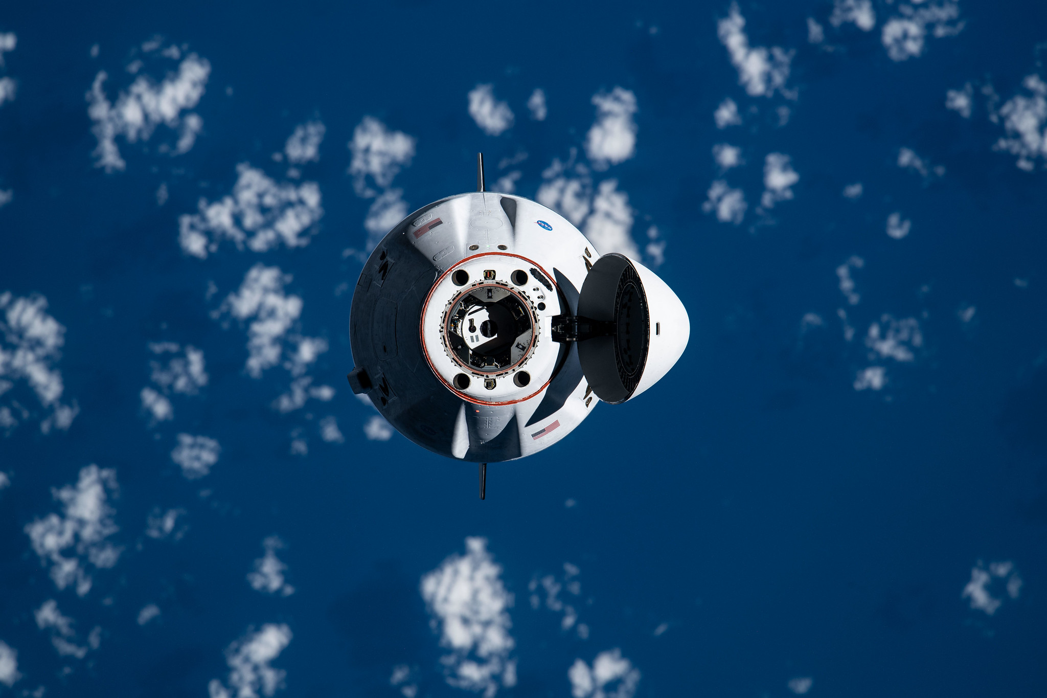 The SpaceX Cargo Dragon vehicle approaches the International Space Station for an autonomous docking to the Harmony module's forward international docking adapter.