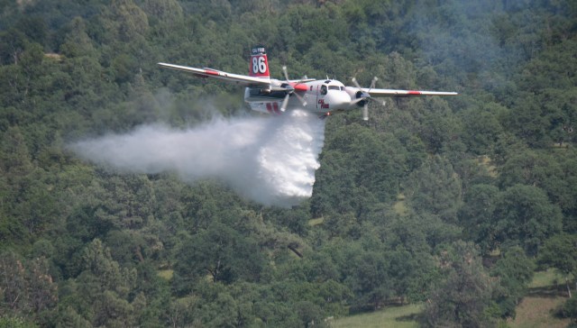 An air tanker drops water during an aerial firefighting training event