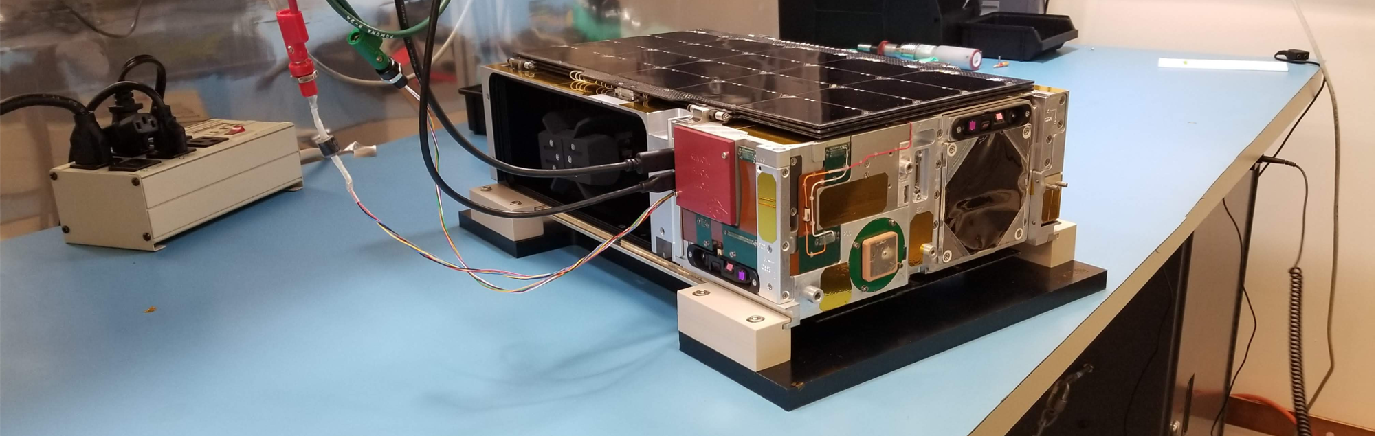 The CUTE cubesat on a bench in a lab.