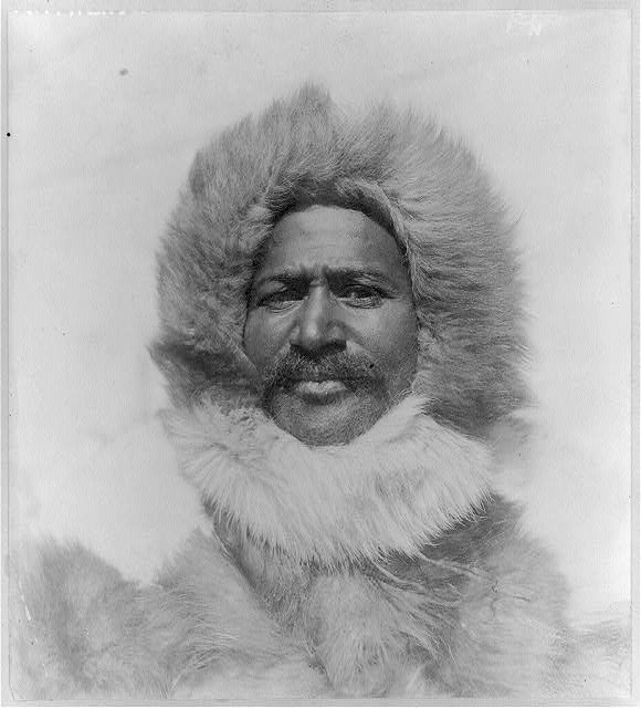Black and white photo of a man in a fur coat.